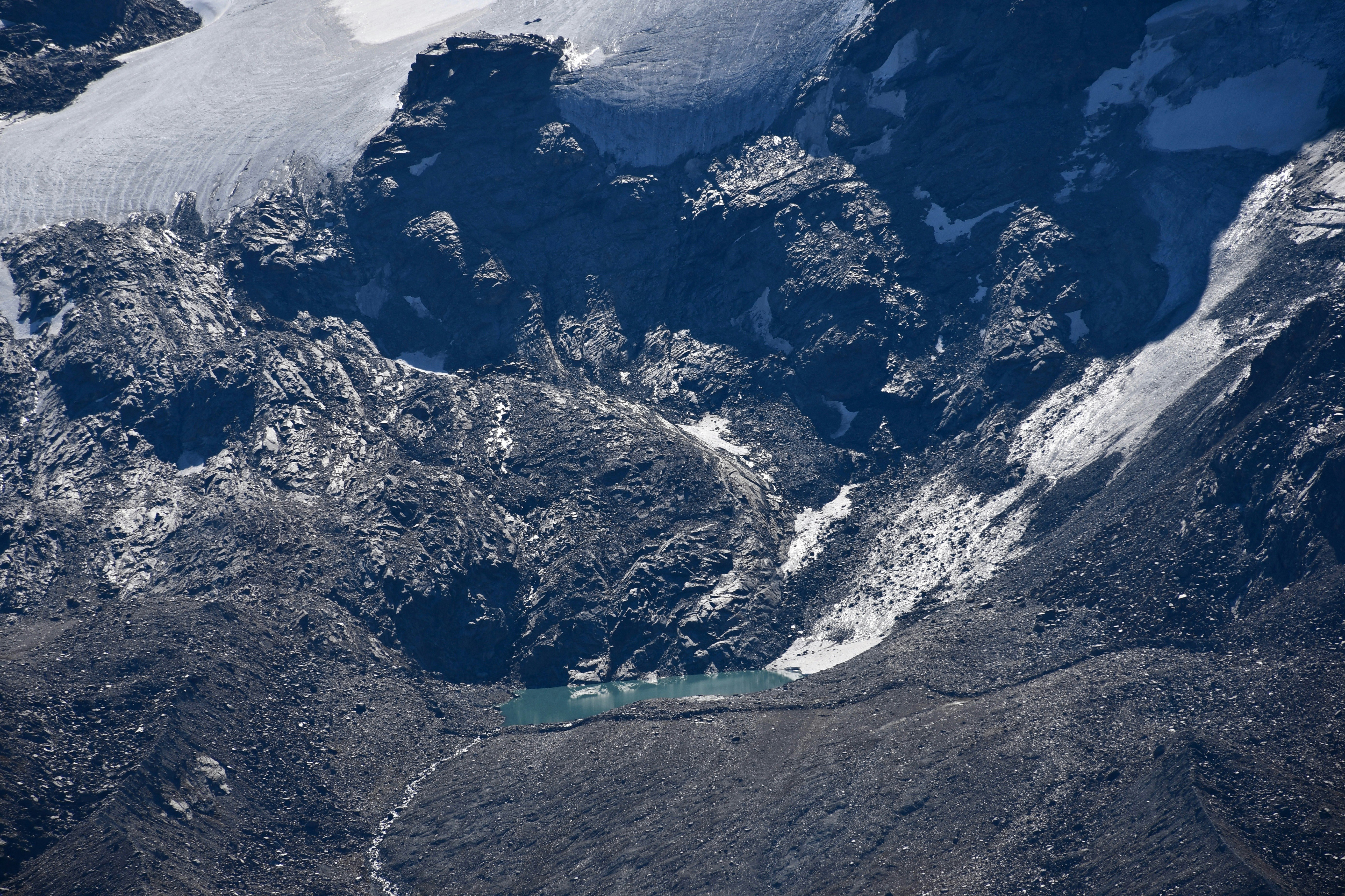 white and black mountains near body of water during daytime